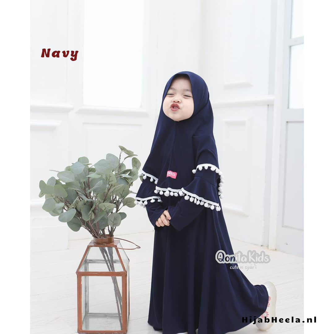 a woman standing in front of a window with a flower