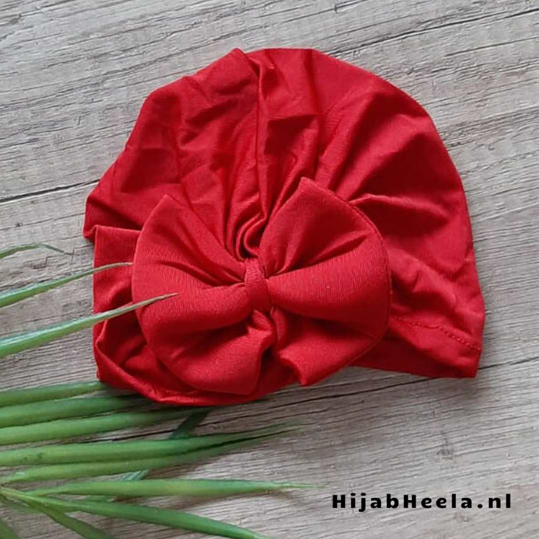 a red umbrella sitting on top of a bed
