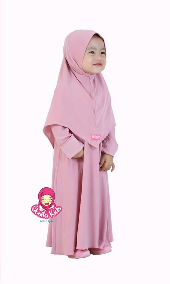 a little girl in a pink dress holding a cell phone 